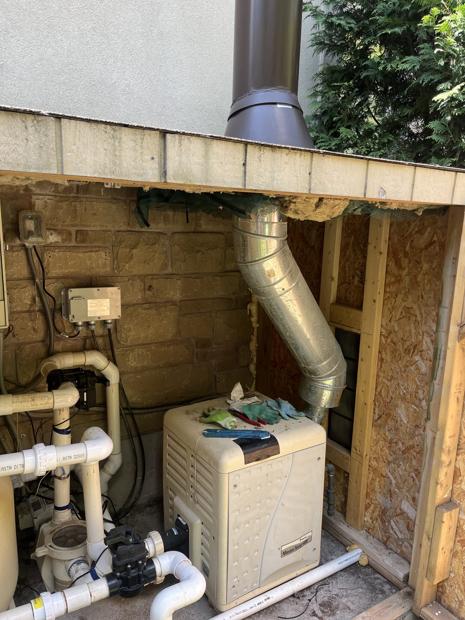 Pentair heater being illegally vented. Improper structure around pool equipment.